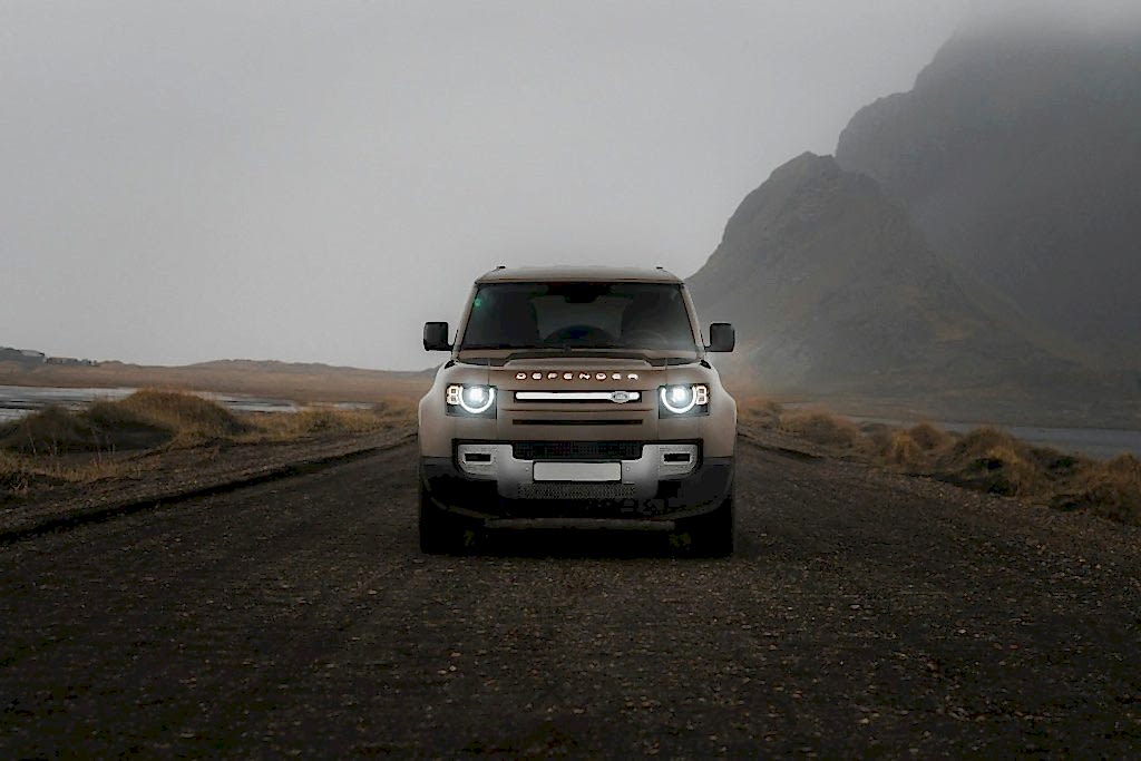 A jeep is driving down a dirt road