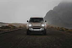 A jeep is driving down a dirt road