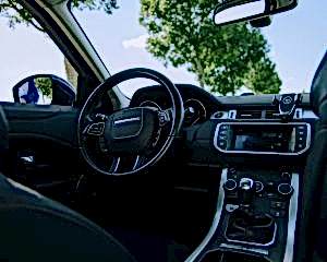 the interior of a car with a steering wheel and dashboard