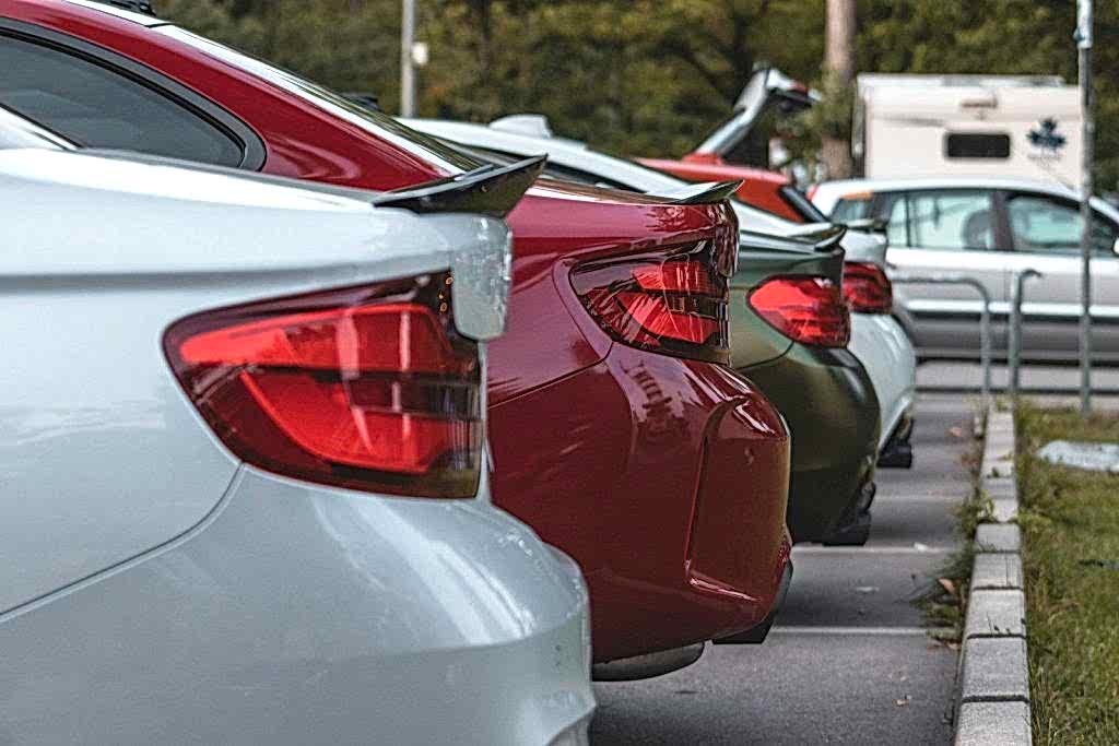 red and silver cars on road during daytime