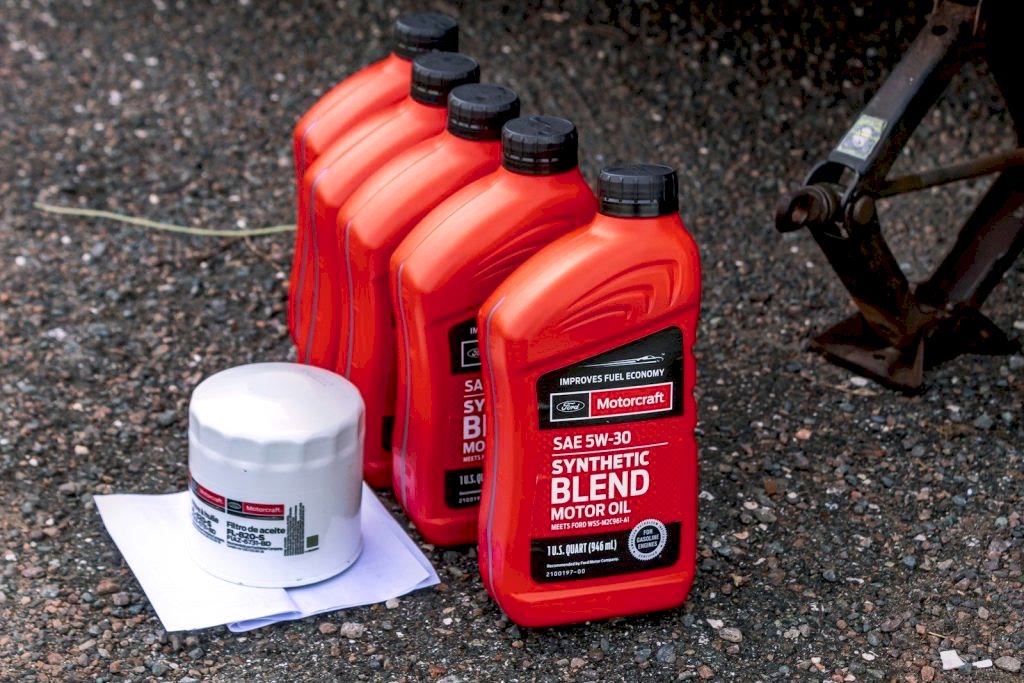 a couple of bottles of motor oil sitting on the ground