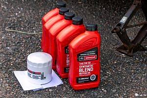 a couple of bottles of motor oil sitting on the ground